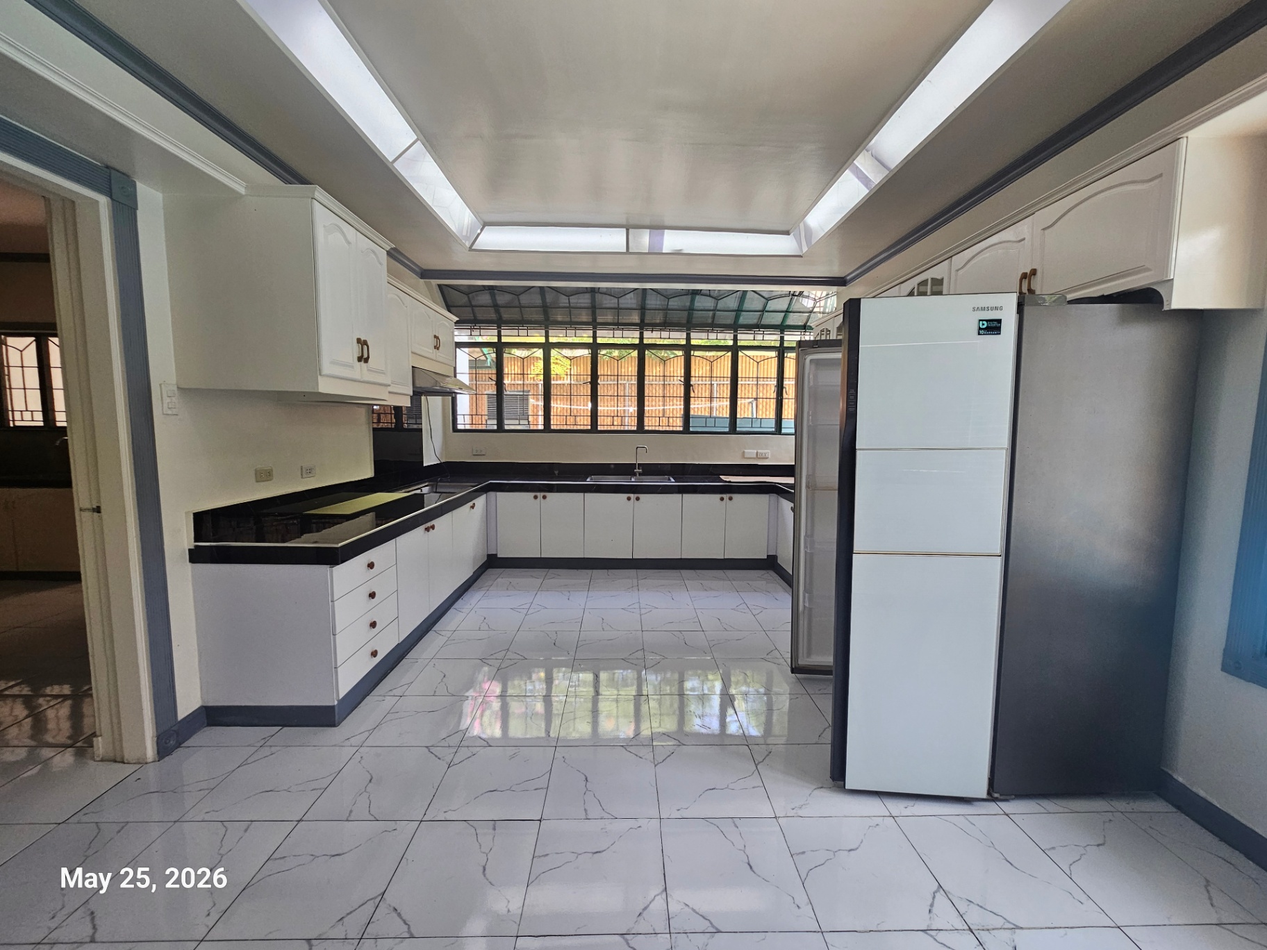 Gourmet kitchen with full cabinetry and glazed roof windows