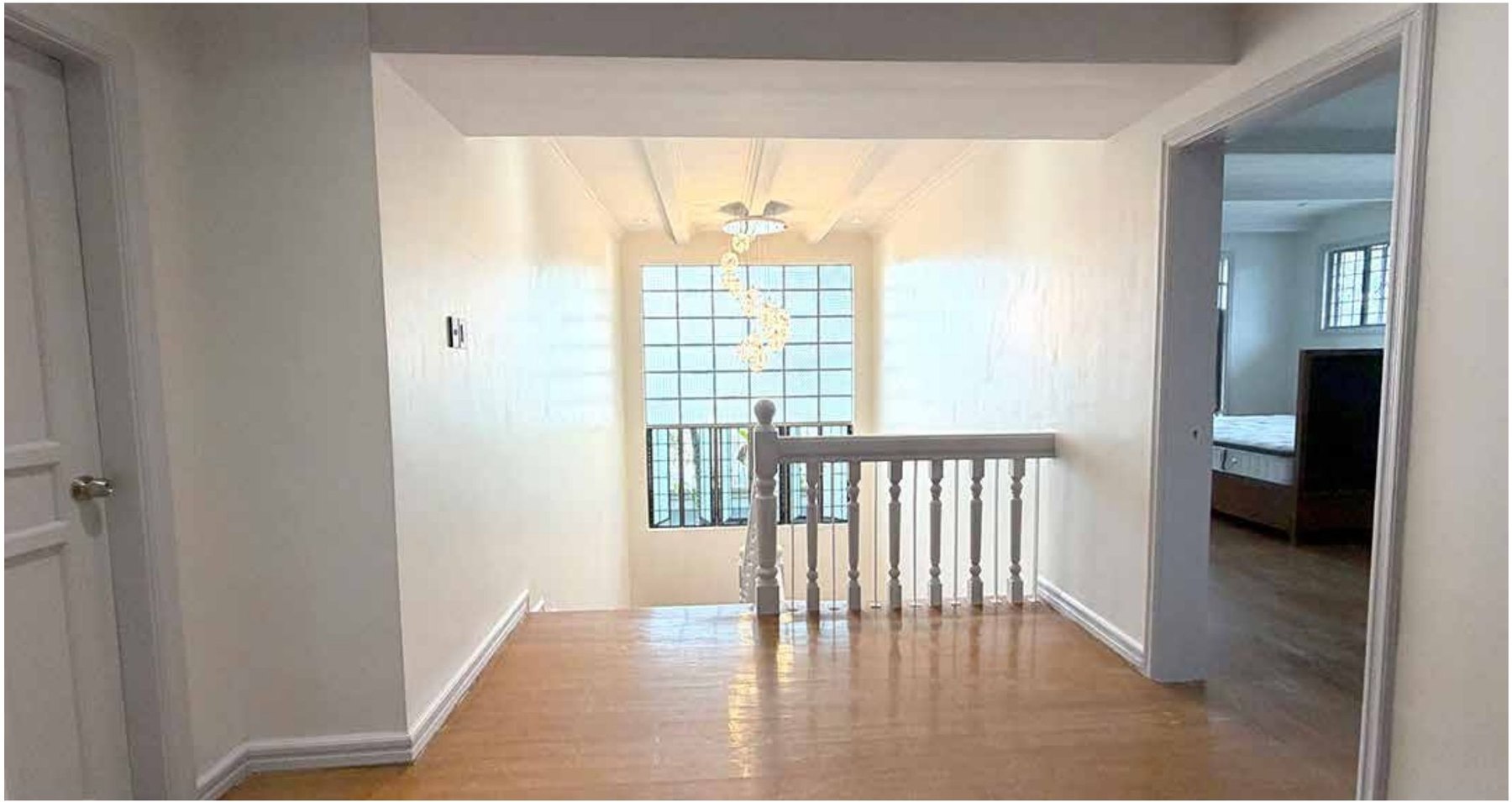 Staircase with timber treads, white railings and glass block window