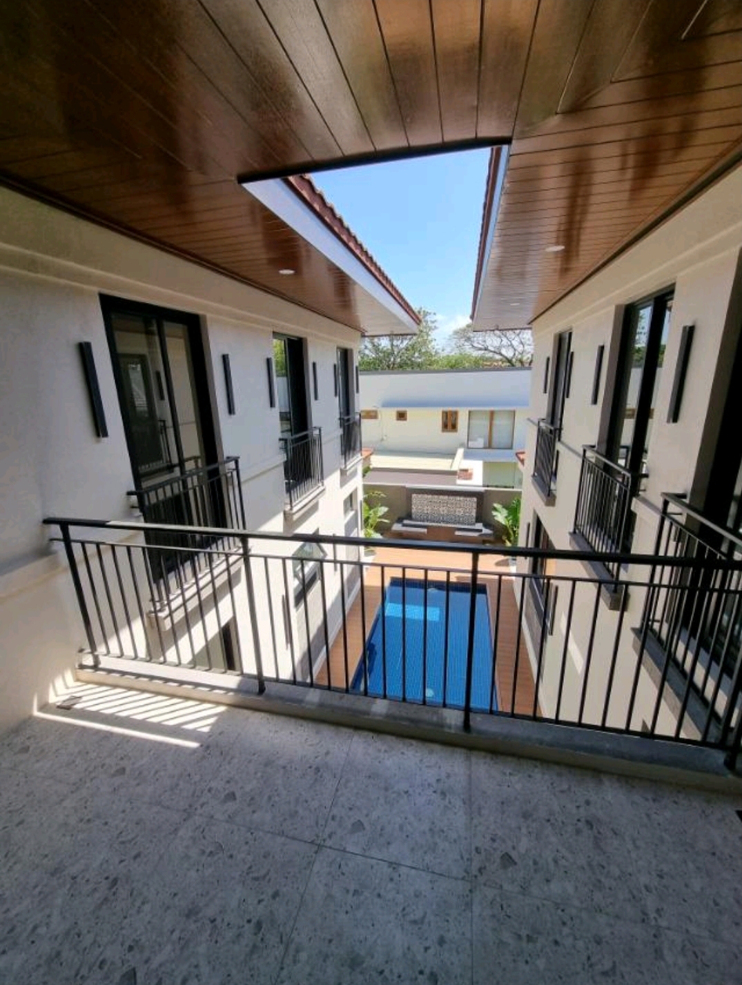 Upper-level gallery overlooking the courtyard pool
