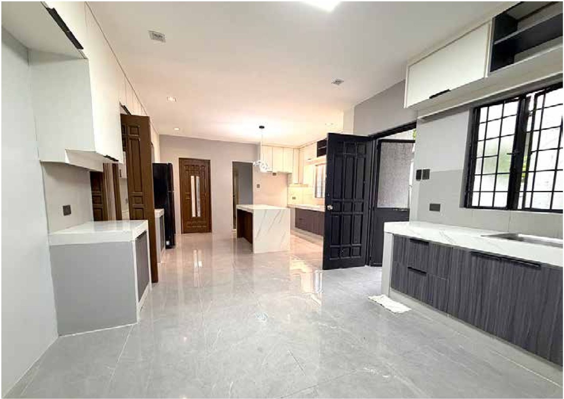 New kitchen with slatted timber island bar and white countertops