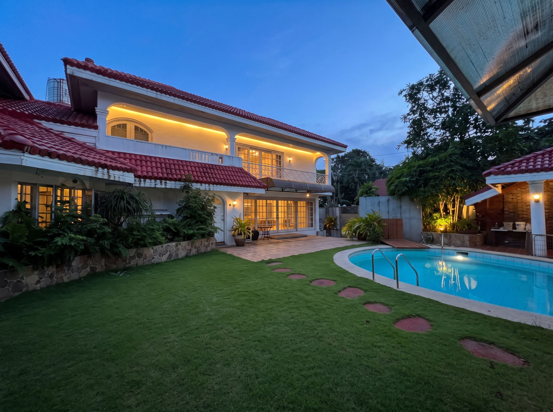 Poolside residence and lawn at dusk — digitally enhanced