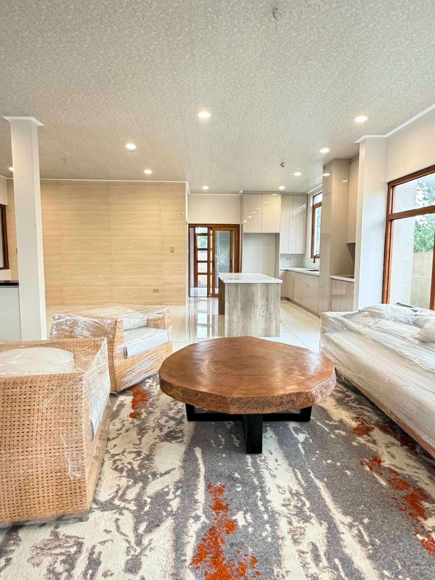 Living area flowing into the open kitchen with a stone island