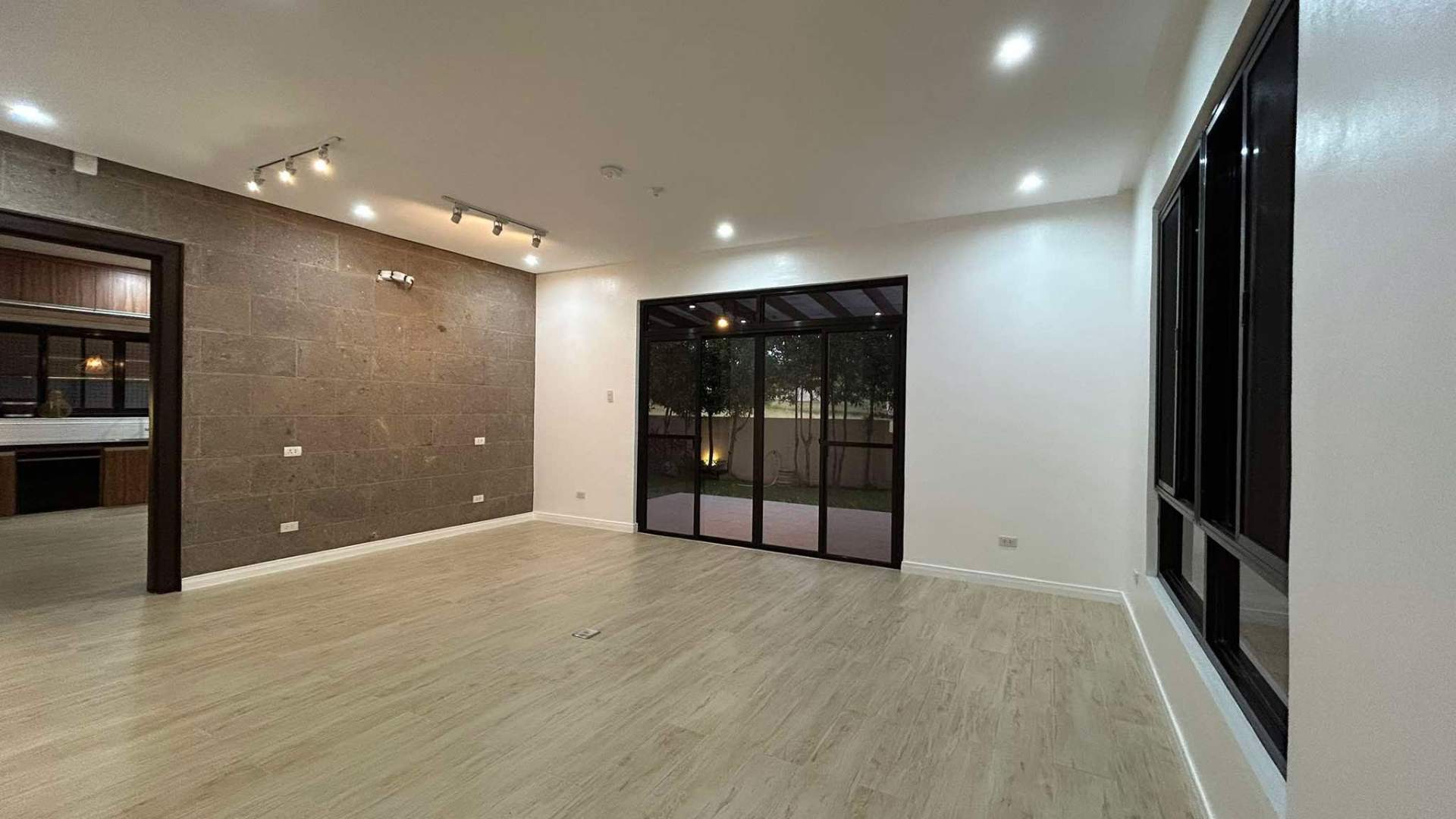 Family room opening to the garden through full-height sliders
