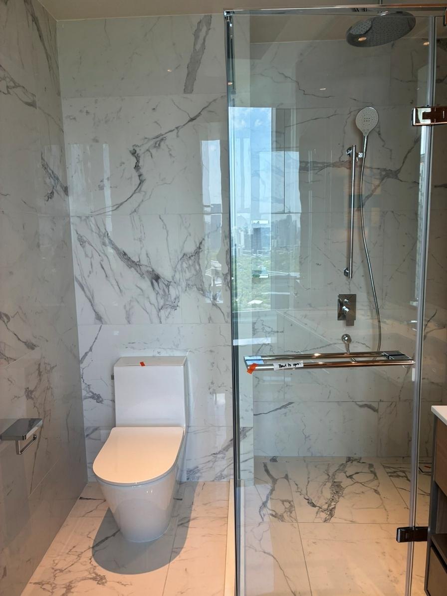 Soaking tub set against a window with city views