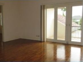 Family area with hardwood flooring and sliding glass doors to the garden