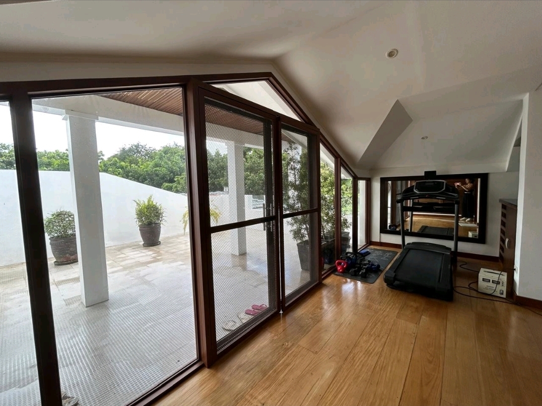 Third-floor home gym opening to the covered lanai