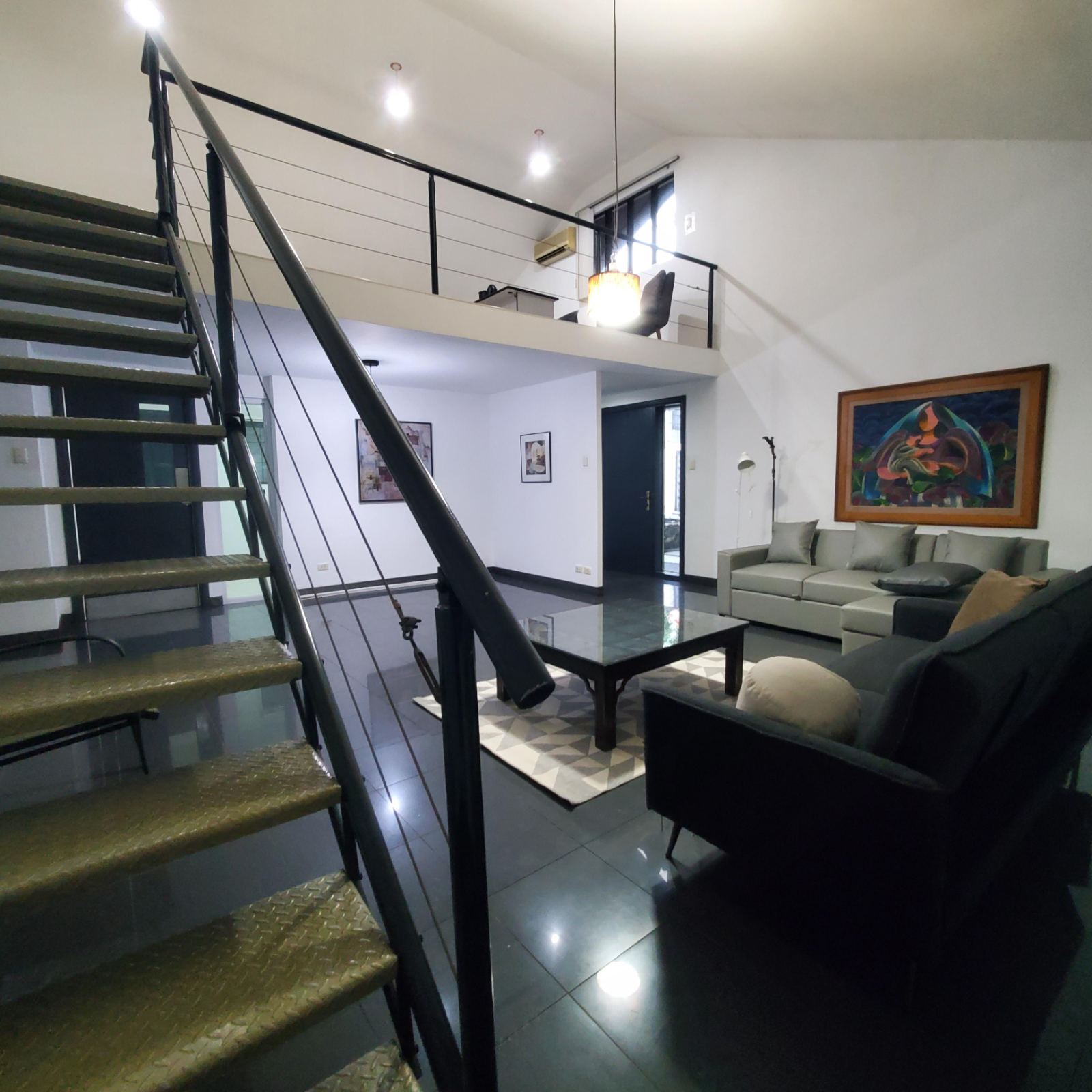 Living room with mezzanine gallery overhead