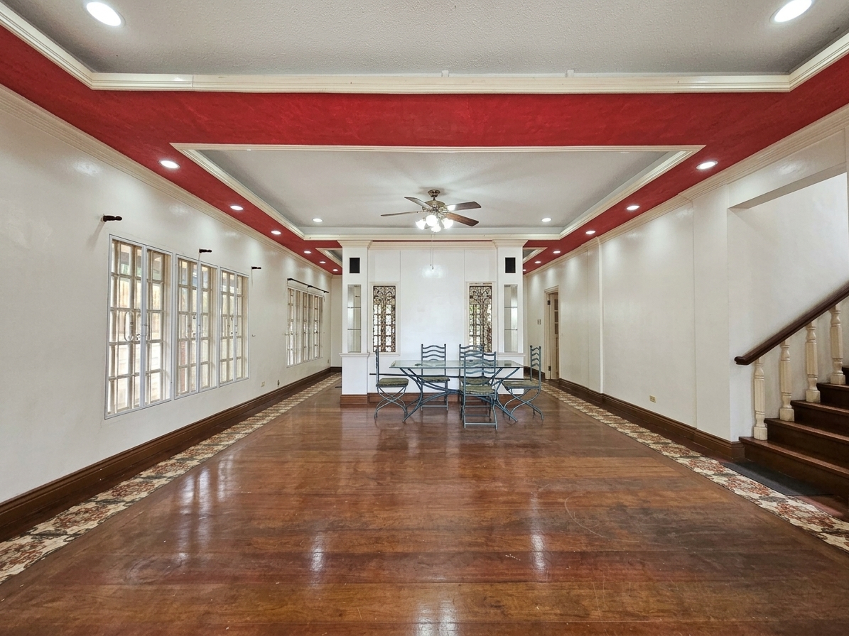 Grand hallway with glossy hardwood floors, chandelier and staircase