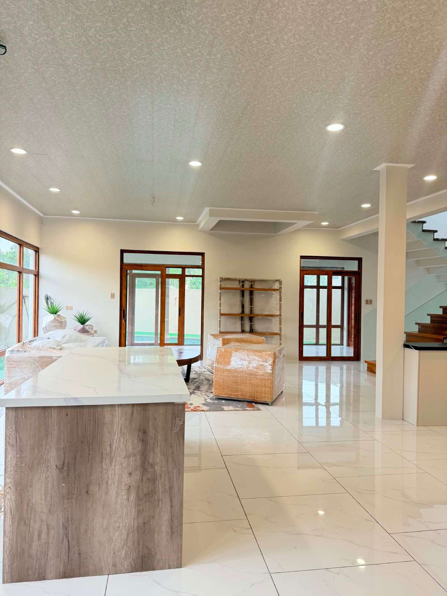 Great room opening to the pool through timber sliding doors