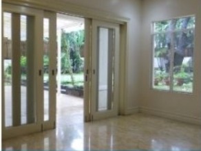 Dining room with wide sliding glass doors opening to the lawn