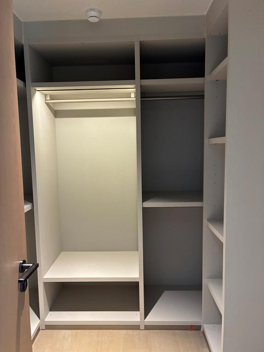 Master bedroom walk-in closet with shelving and hanging rods