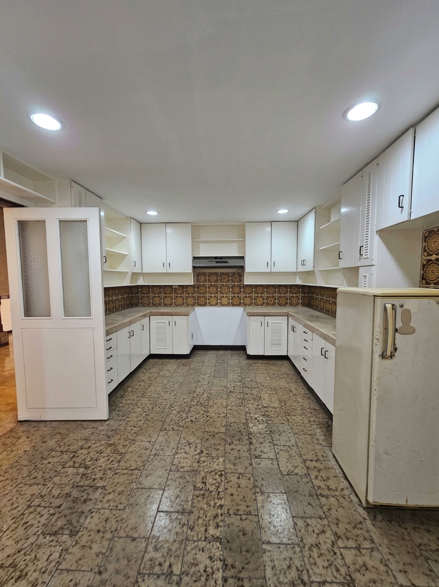 Wide view of the kitchen with generous counters and storage