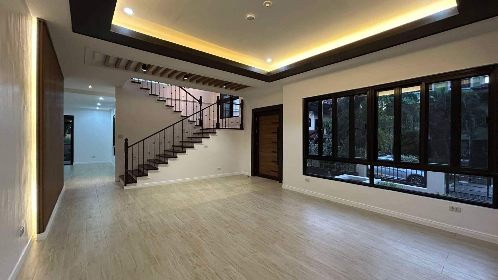 Formal living area with coffered ceiling and dark timber stair