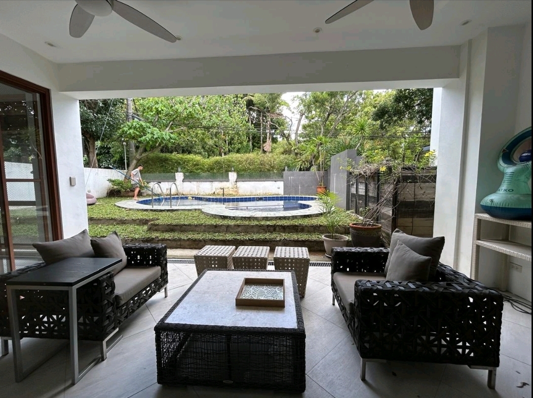 Breezy covered lanai overlooking the pool and koi pond