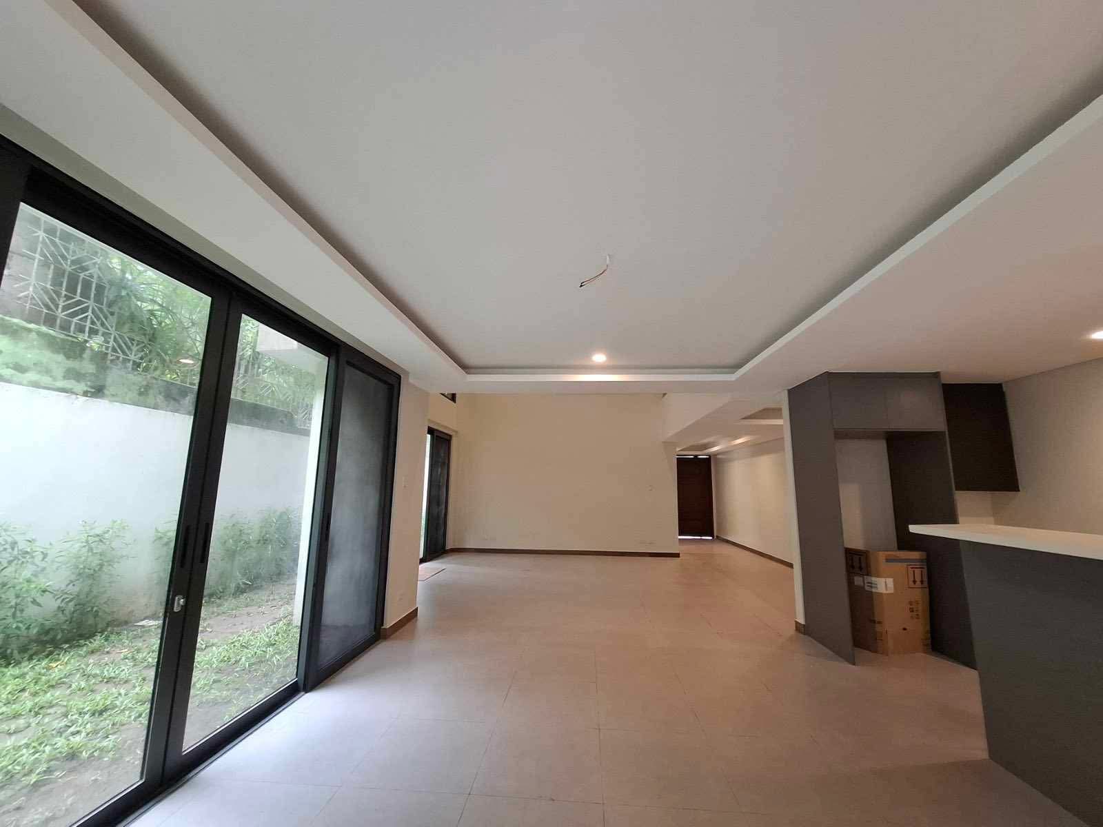 Dining area with full-height sliding glass doors opening to the side garden