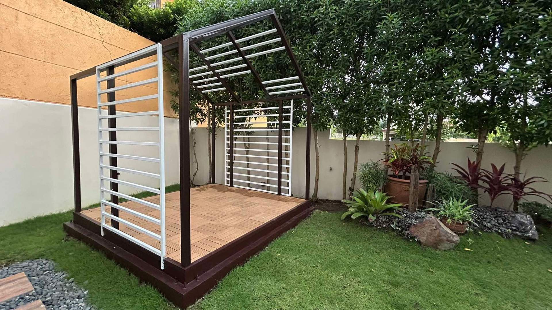 Outdoor gazebo deck framed by greenery