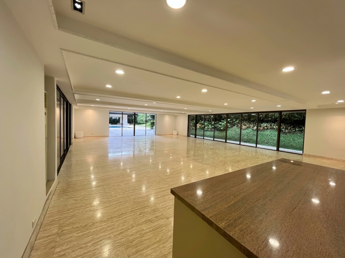 Entertainment room with garden-facing glass walls and stone island