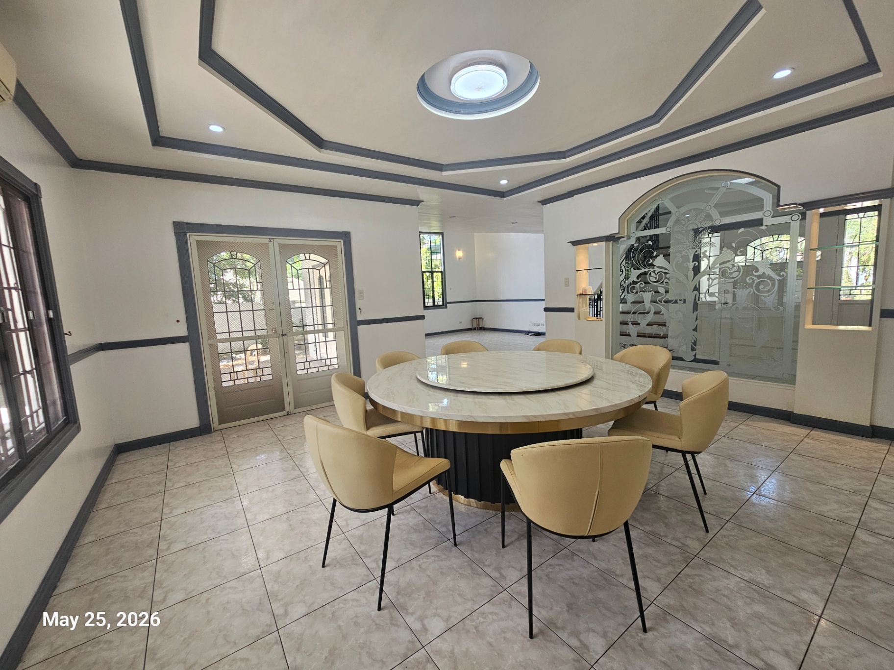 Formal dining room with tray ceiling and skylight