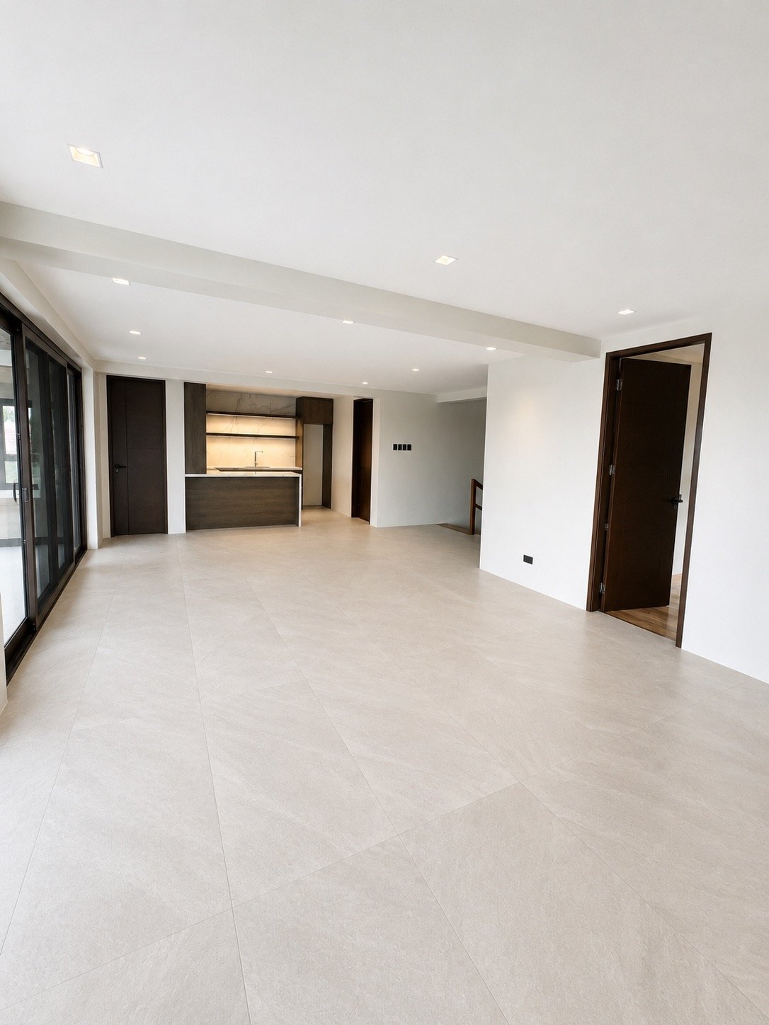 Open great room with kitchen counter and sliding doors to the lanai