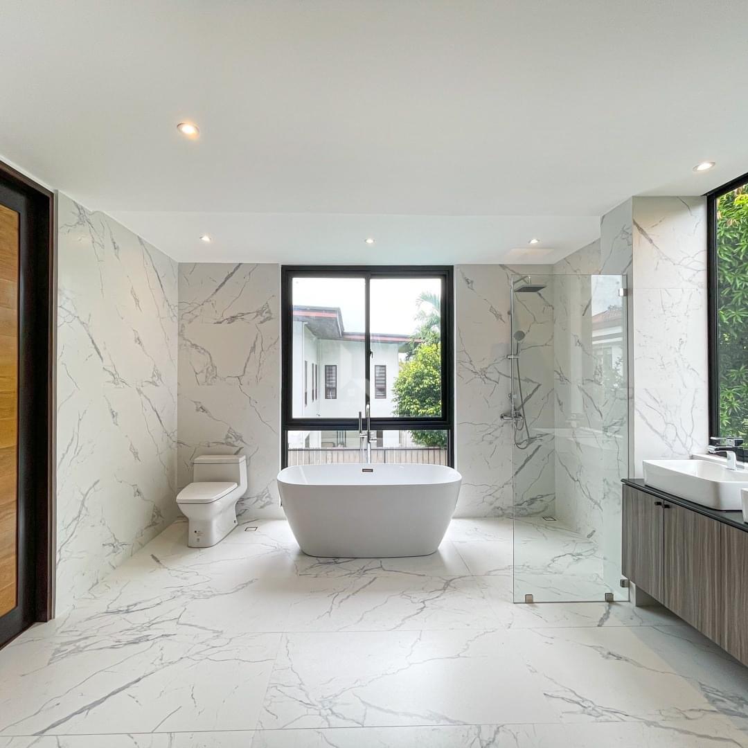 Marble master bathroom with freestanding tub, walk-in shower, and double vanity