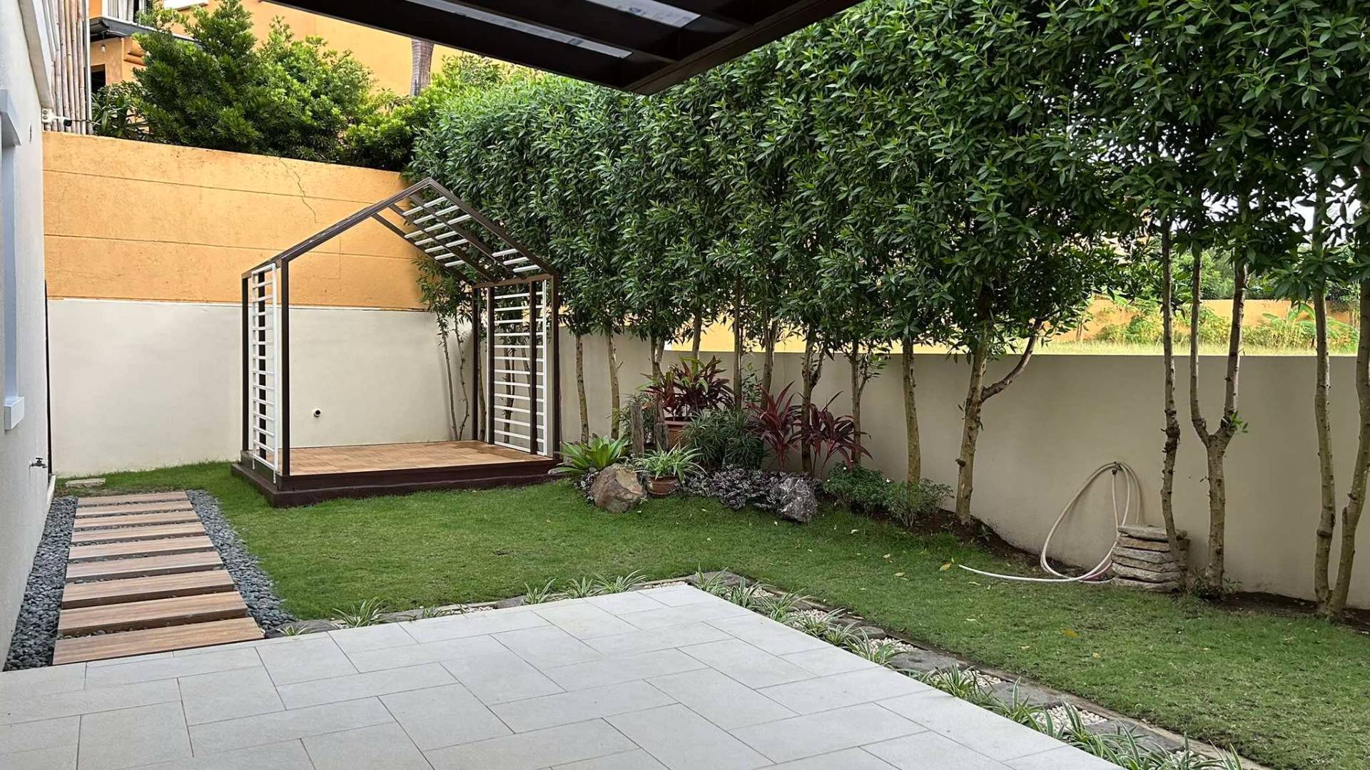 Private garden with mature trees and stepping-stone path