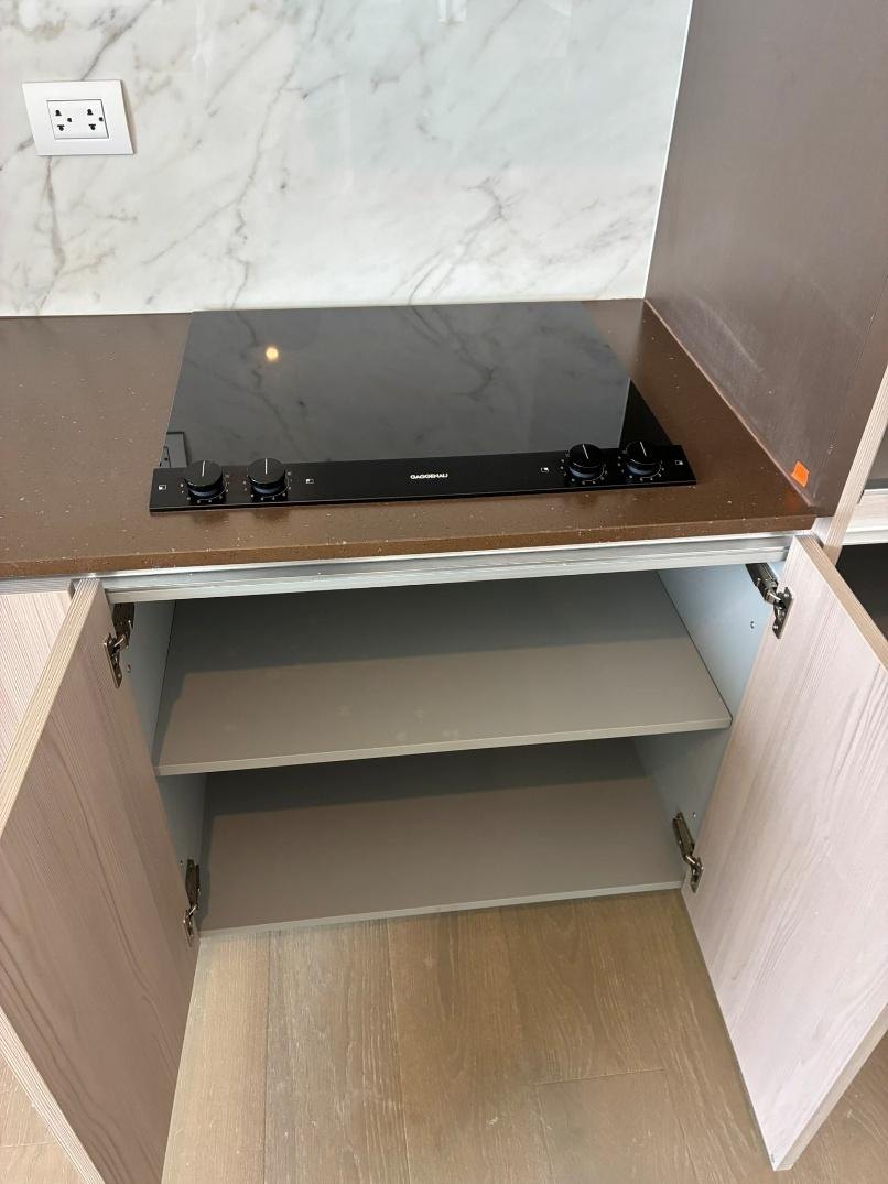Kitchen cabinetry with cooktop and wine cooler
