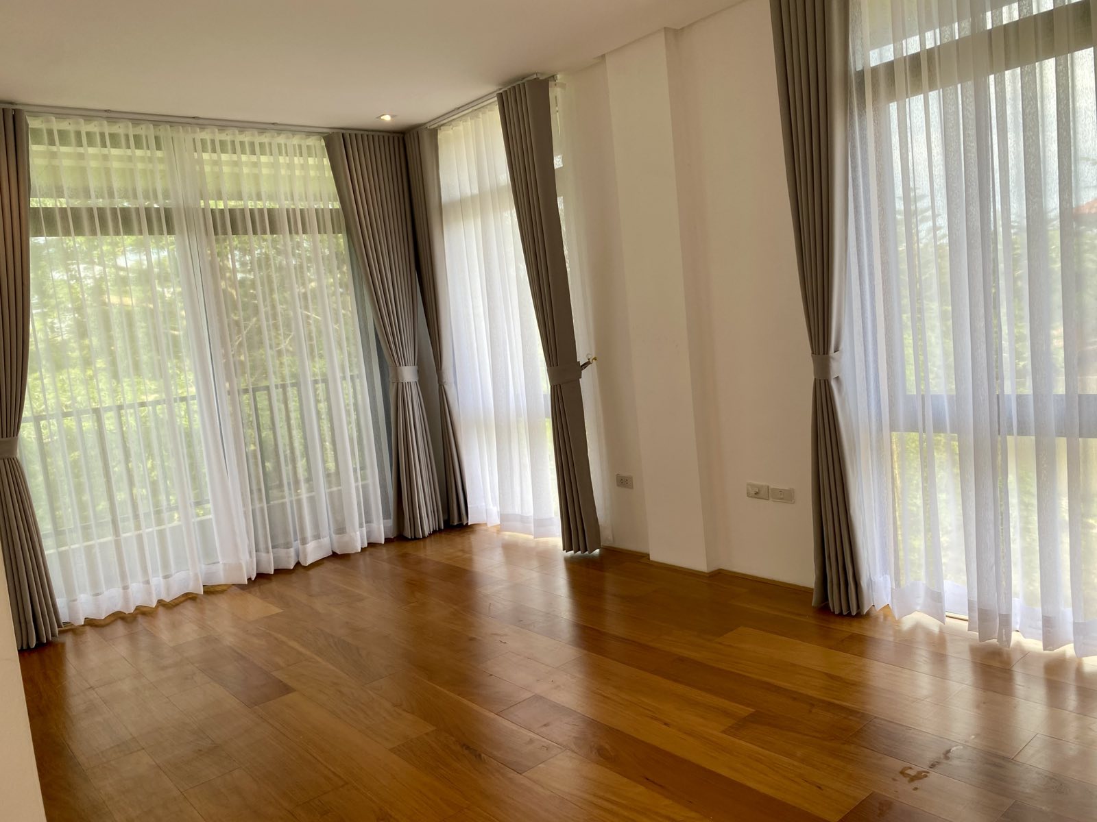 Master's bedroom with engineered narra flooring and balcony windows