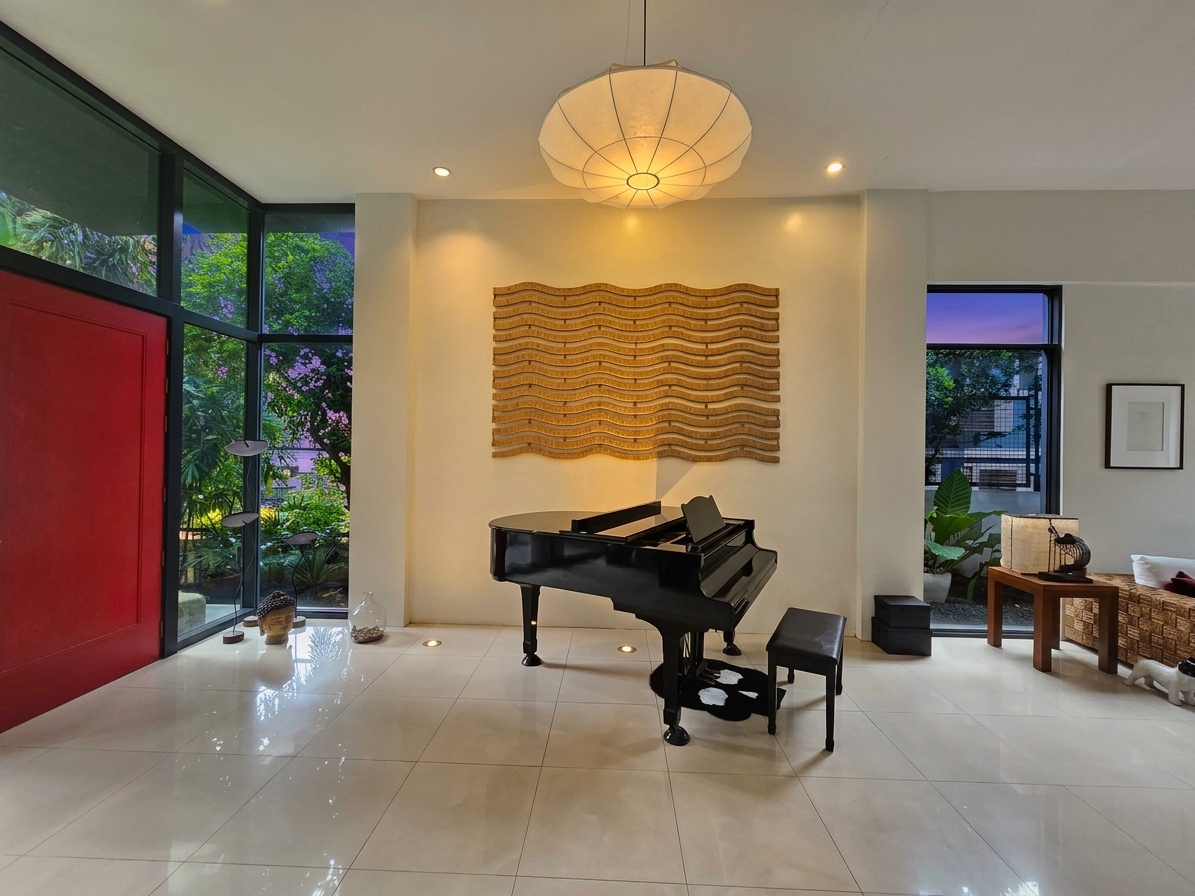 Piano room framed by full-height garden windows