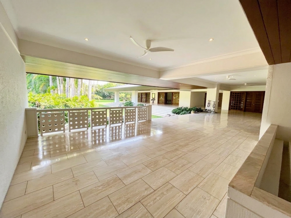 Wide covered lanai with ceiling fans overlooking the garden