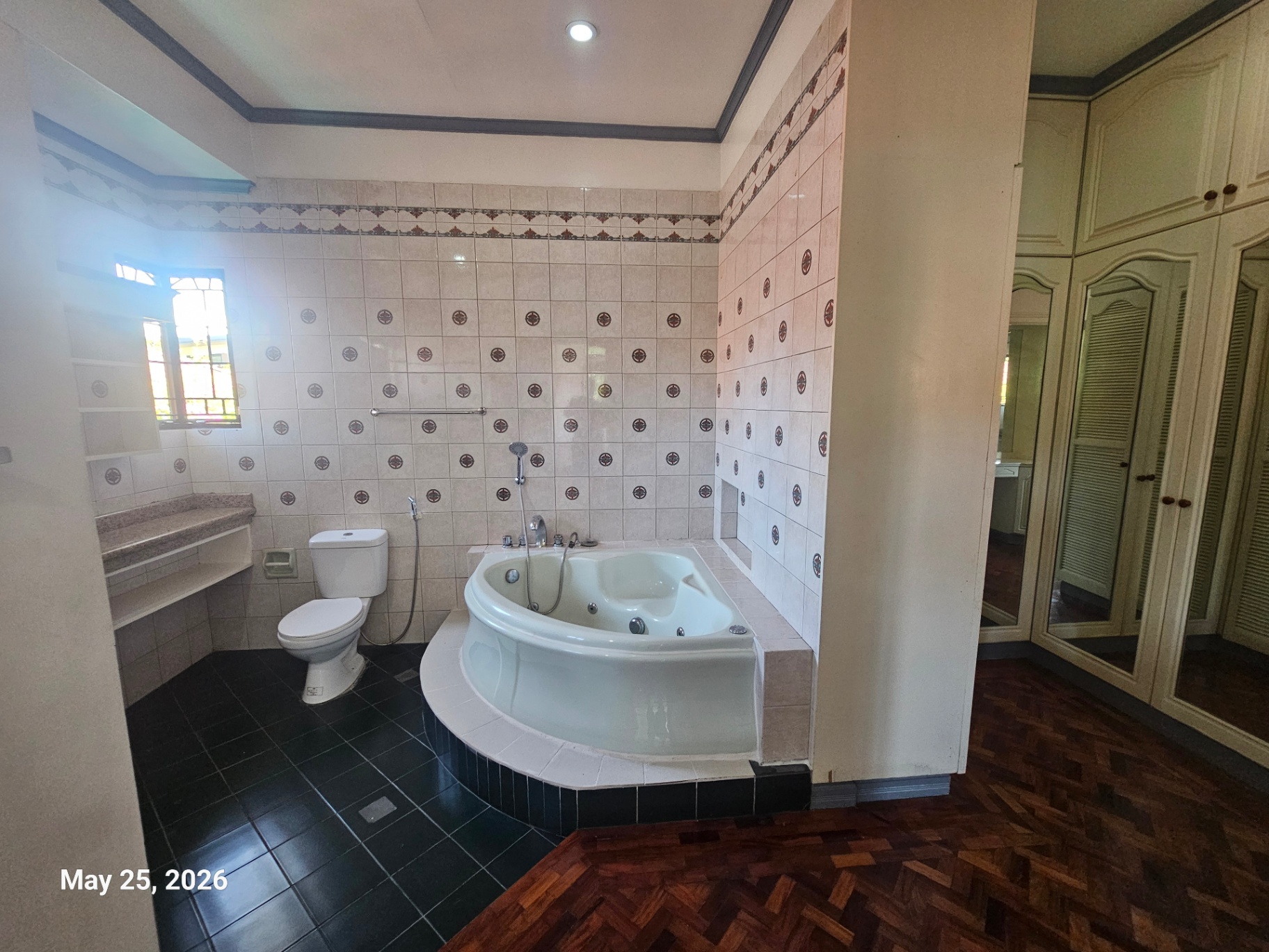 Bathroom with soaking tub and mirrored closet