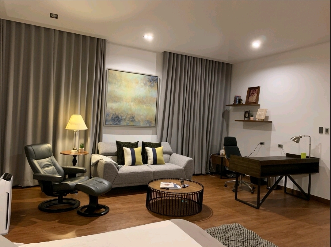 Second bedroom suite arranged with a lounge seating area and study desk