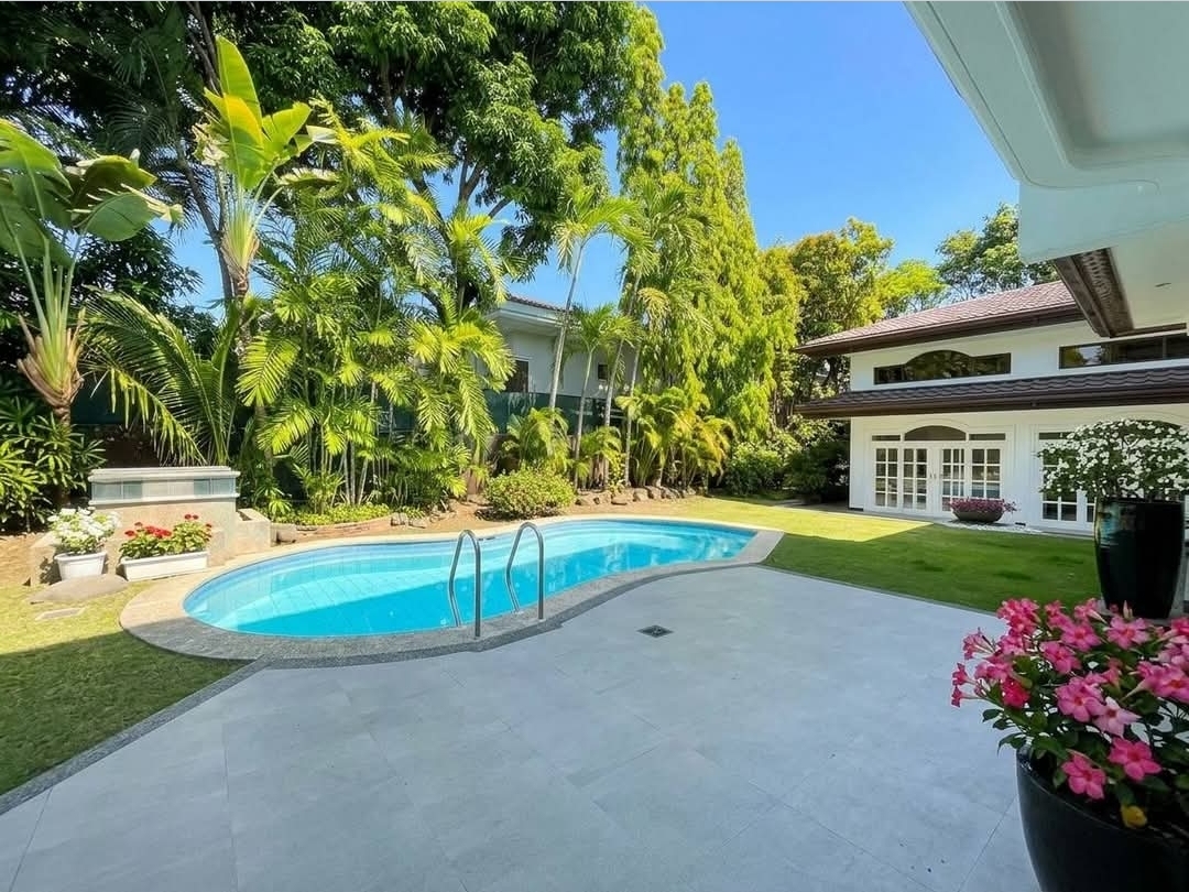 Swimming pool set within the landscaped garden backyard