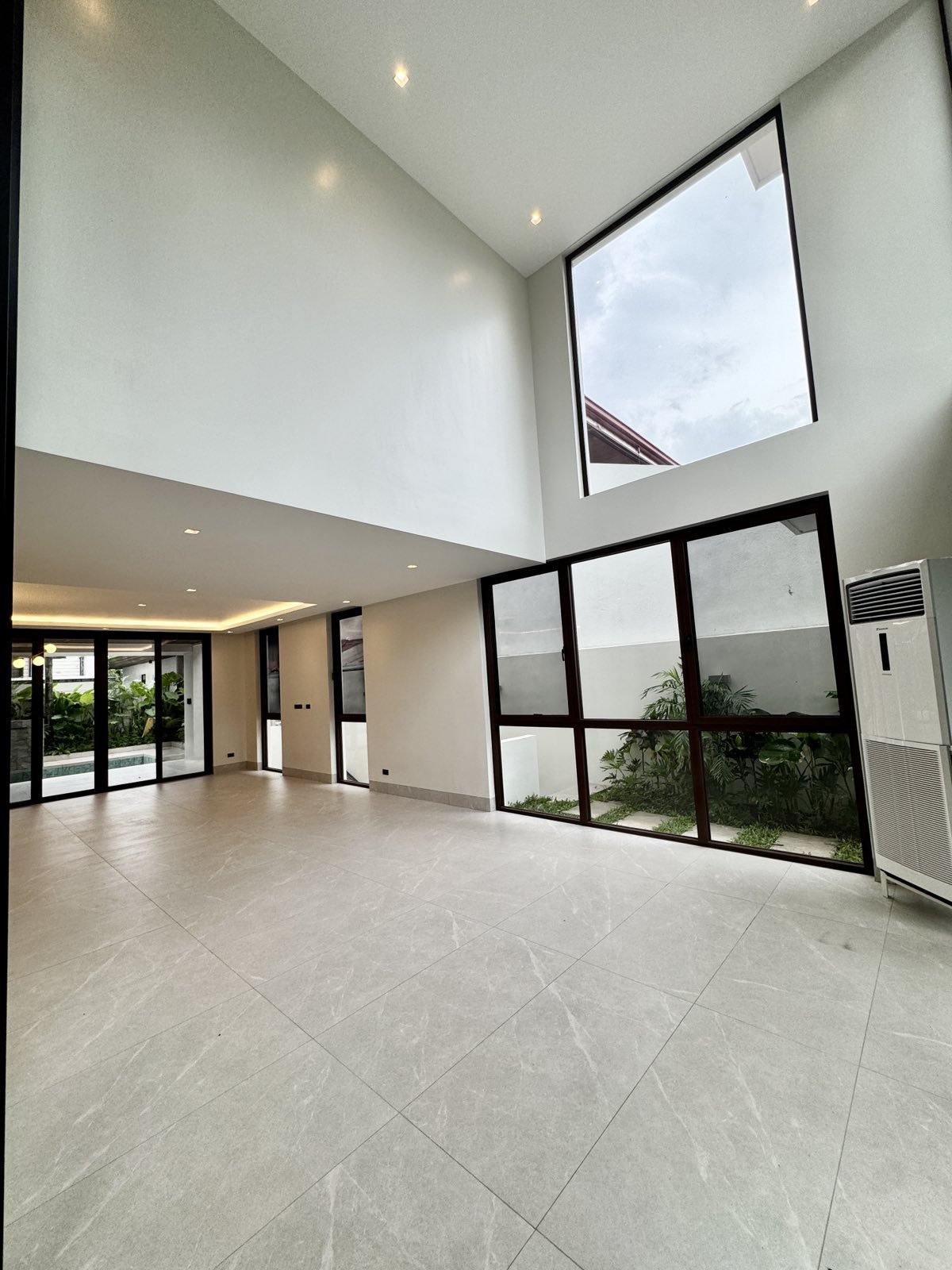 Double-height hall with clerestory windows and courtyard garden