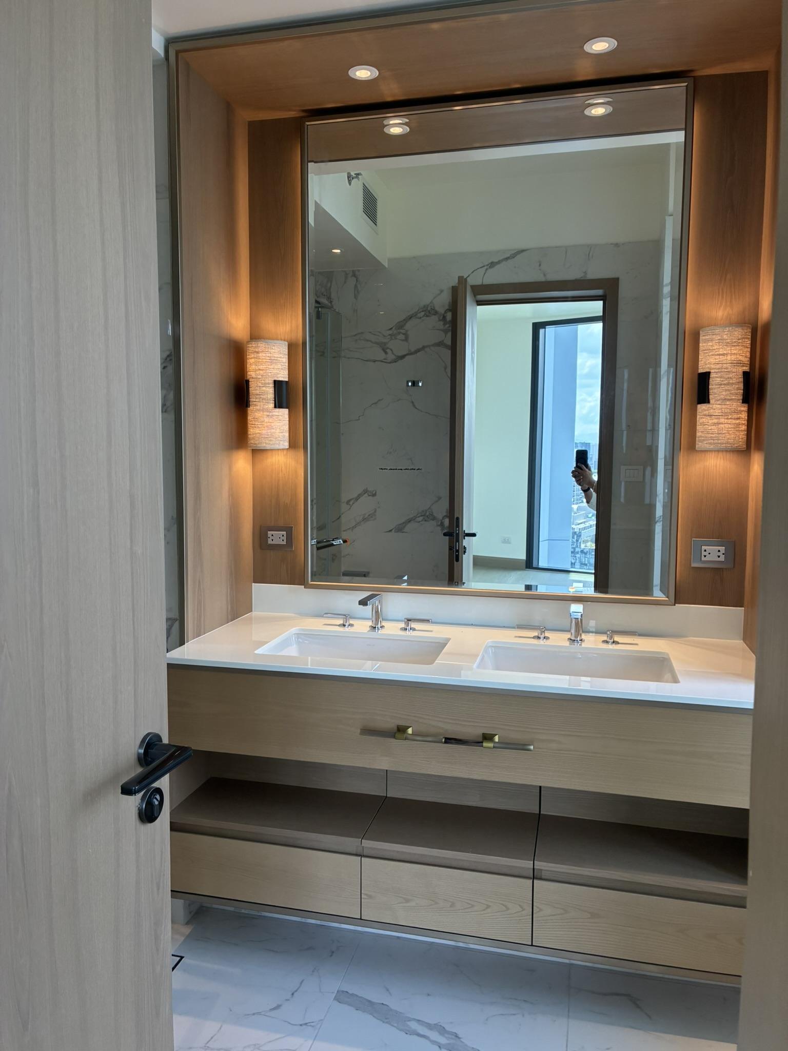 Master bathroom with twin-sink wood vanity and large mirror