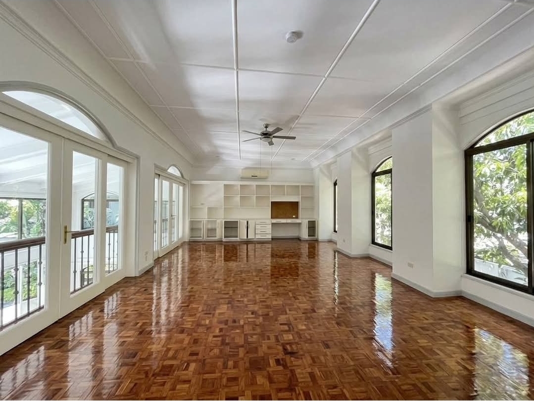 Music room with built-in shelving and balcony access