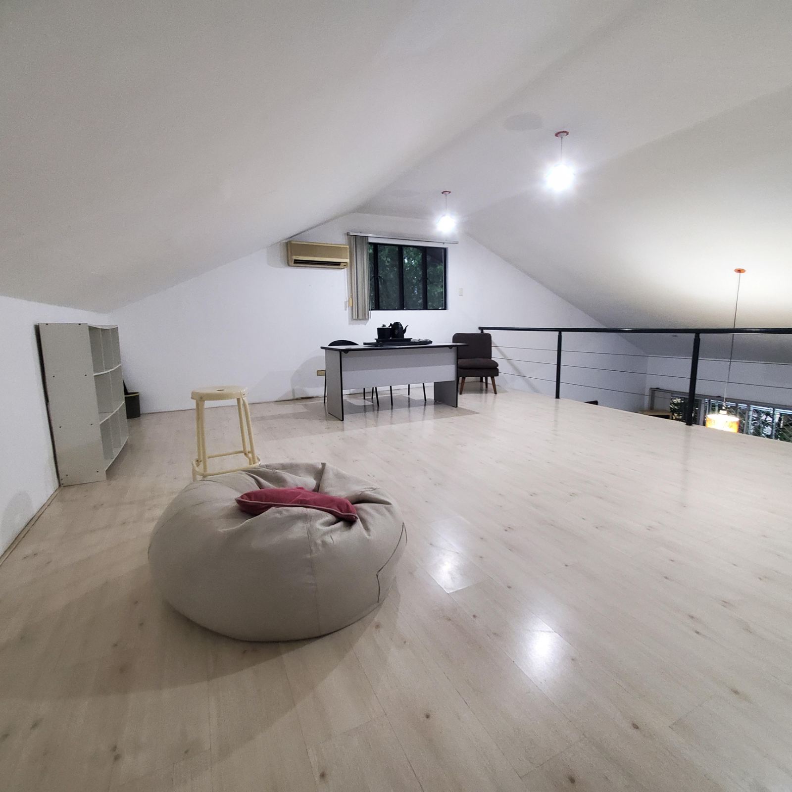 Wide mezzanine loft under the pitched ceiling