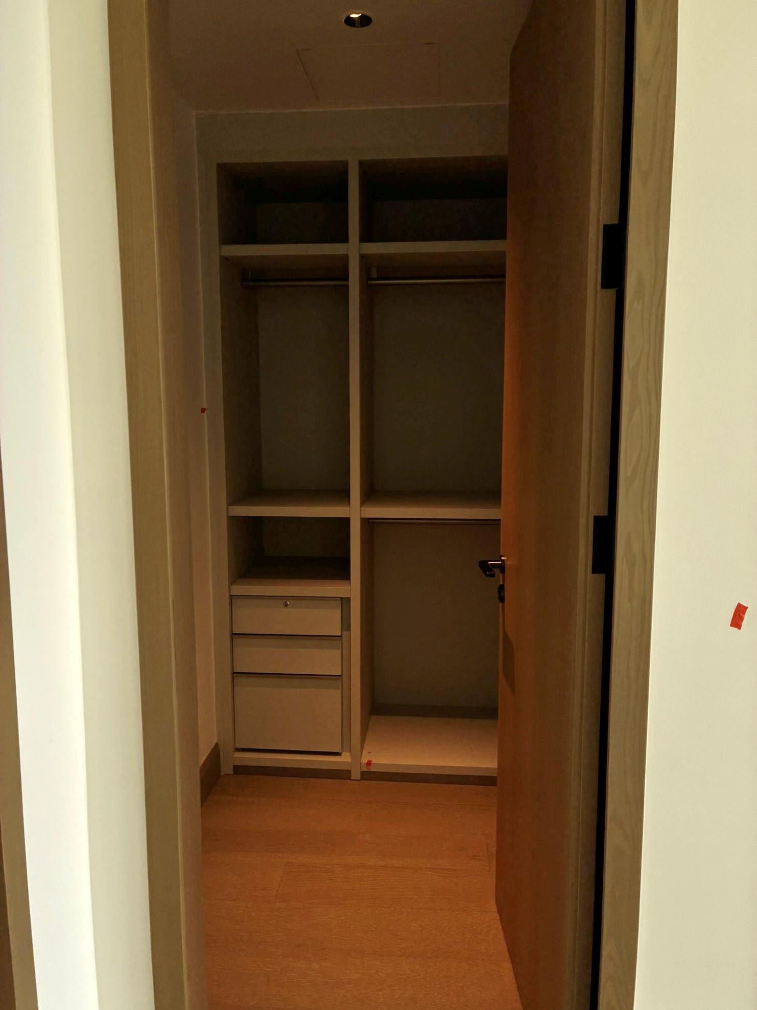 Second bedroom walk-in closet with shelving and drawers