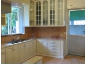 Fitted kitchen with cabinetry and garden windows