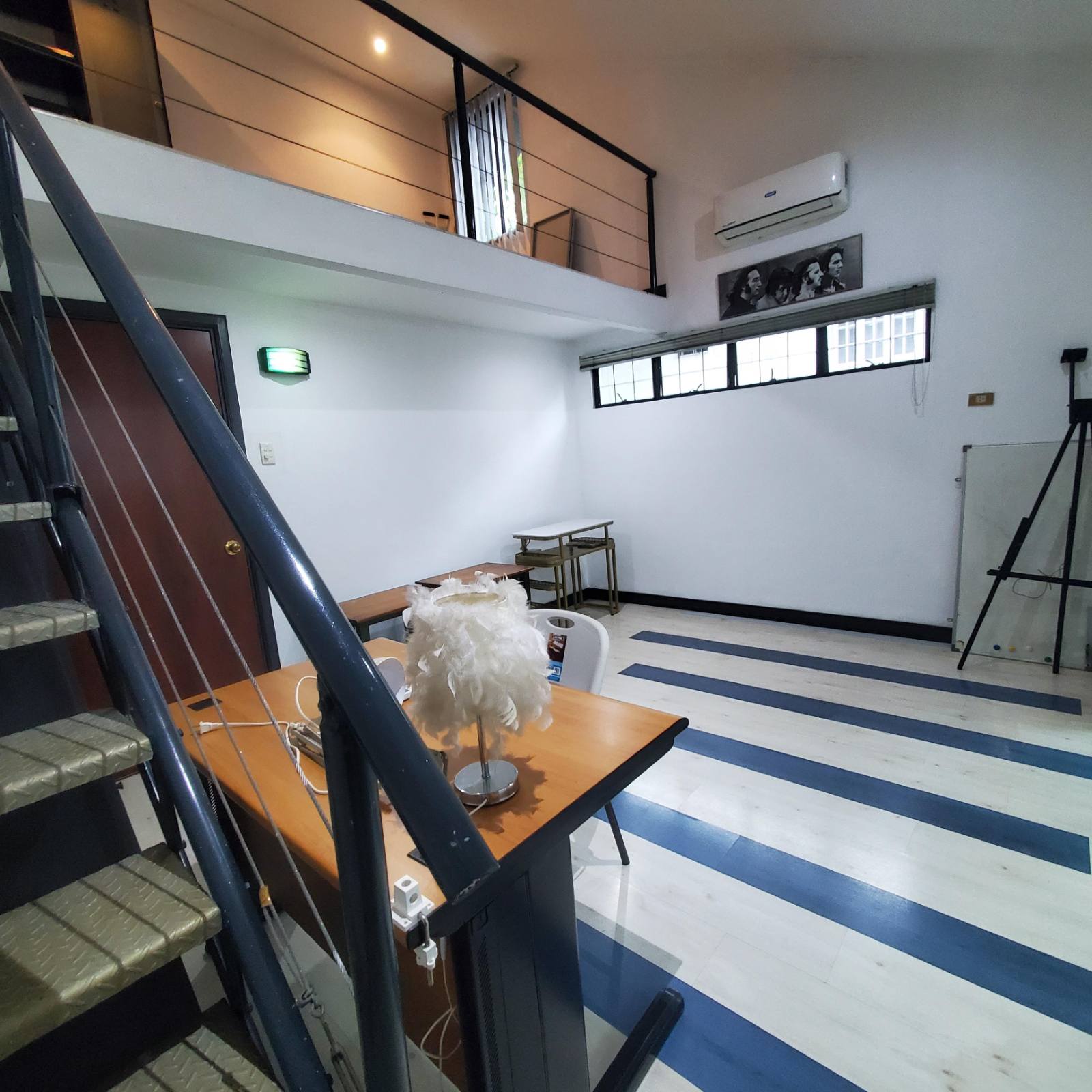 Ground-floor flexible room below the mezzanine with garden windows