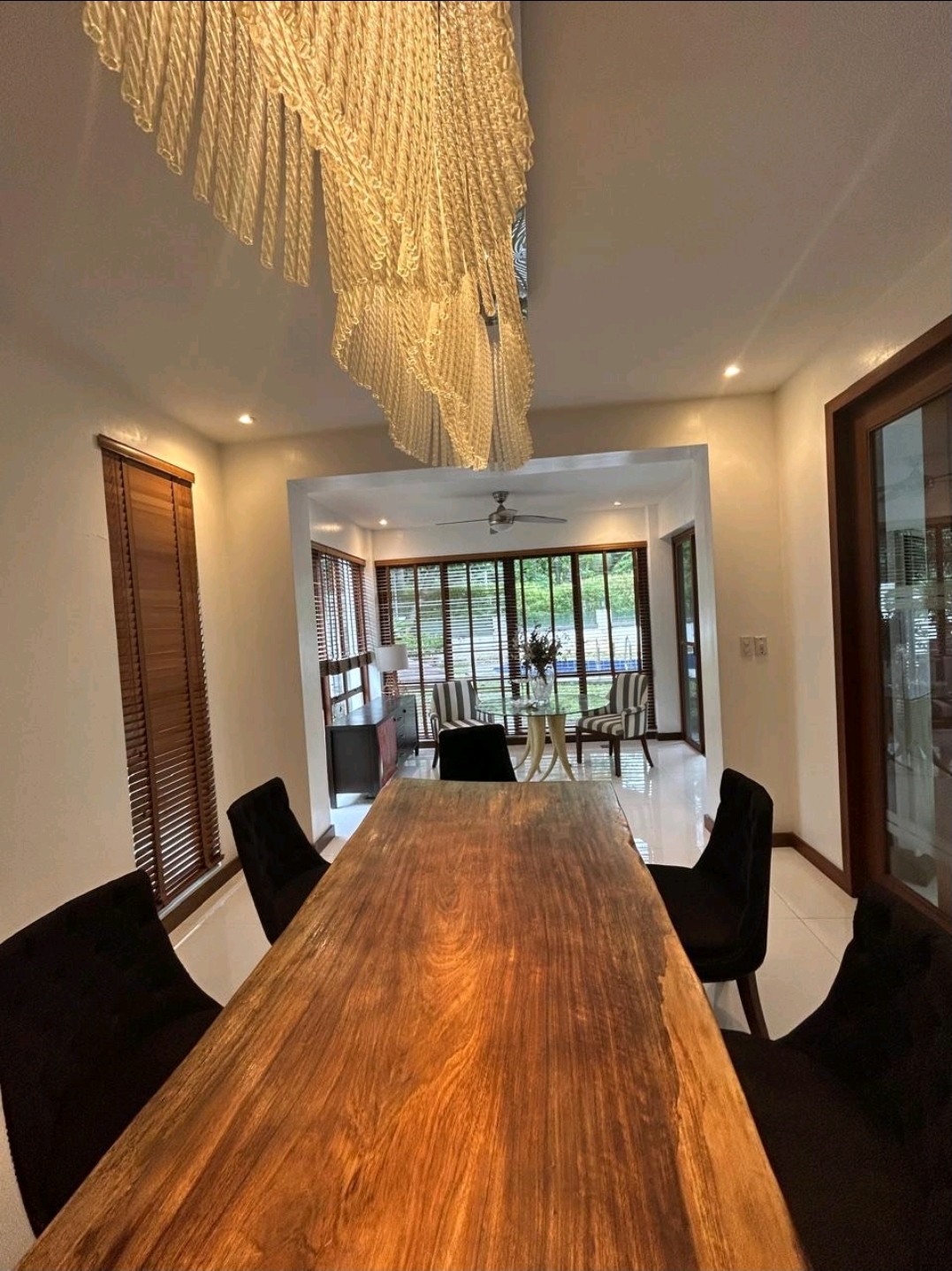 Dining room with live-edge hardwood table and crystal chandelier