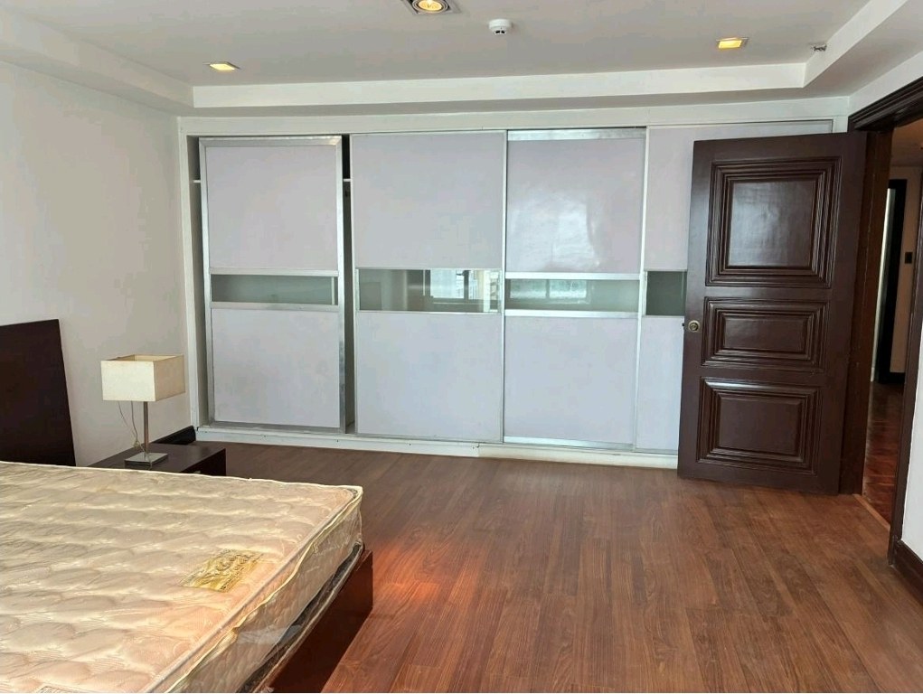 Master bedroom wall of built-in wardrobes with frosted glass sliding doors