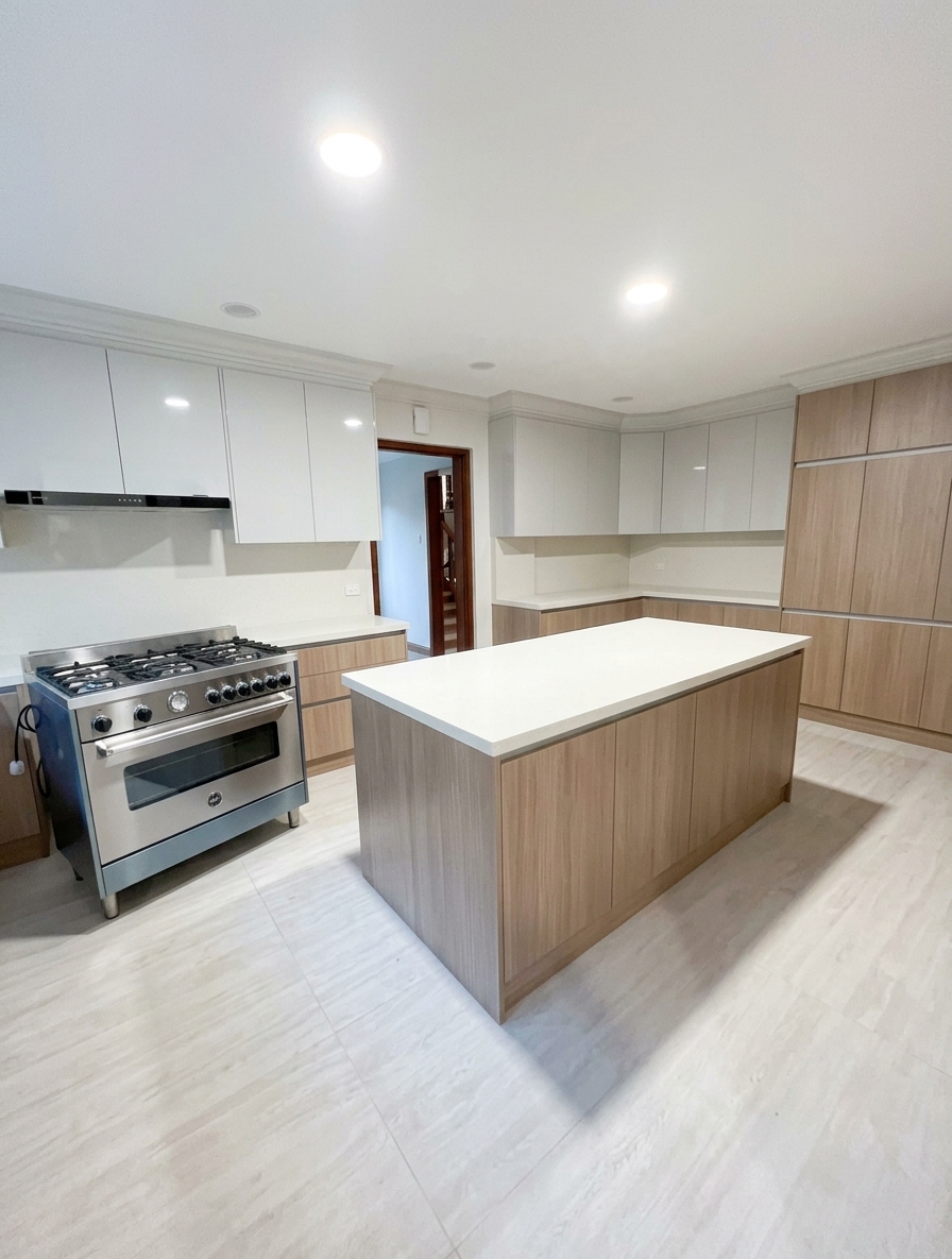 Clean kitchen with center island and full-height cabinets
