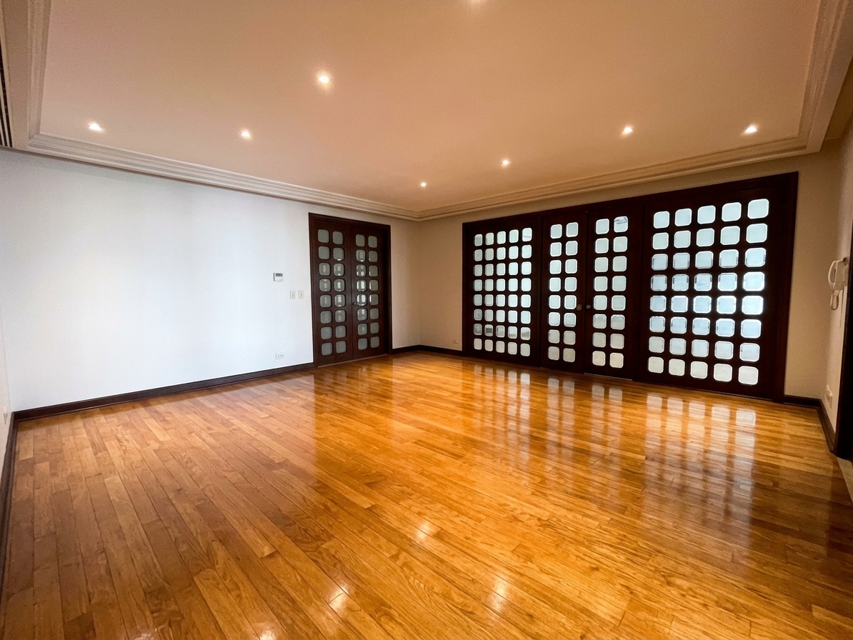 Bedroom with polished hardwood floors and capiz-style sliding panels