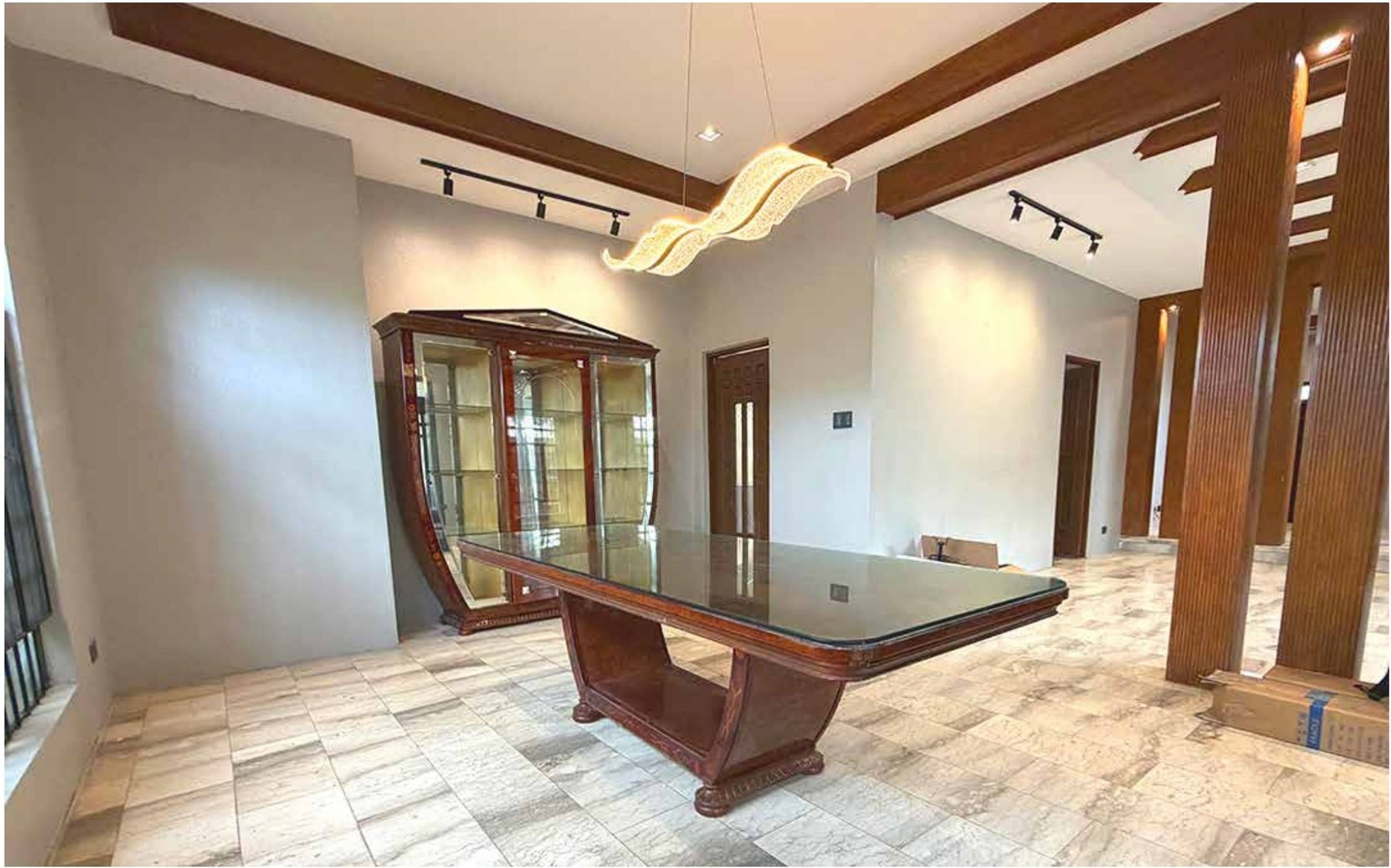 Dining area with a large wooden table and display cabinet