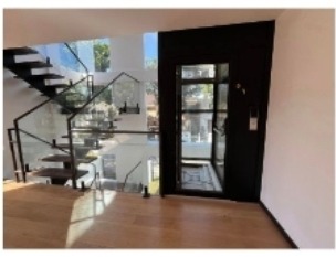 Second floor landing with floating stairs, glass railings, and hardwood floors
