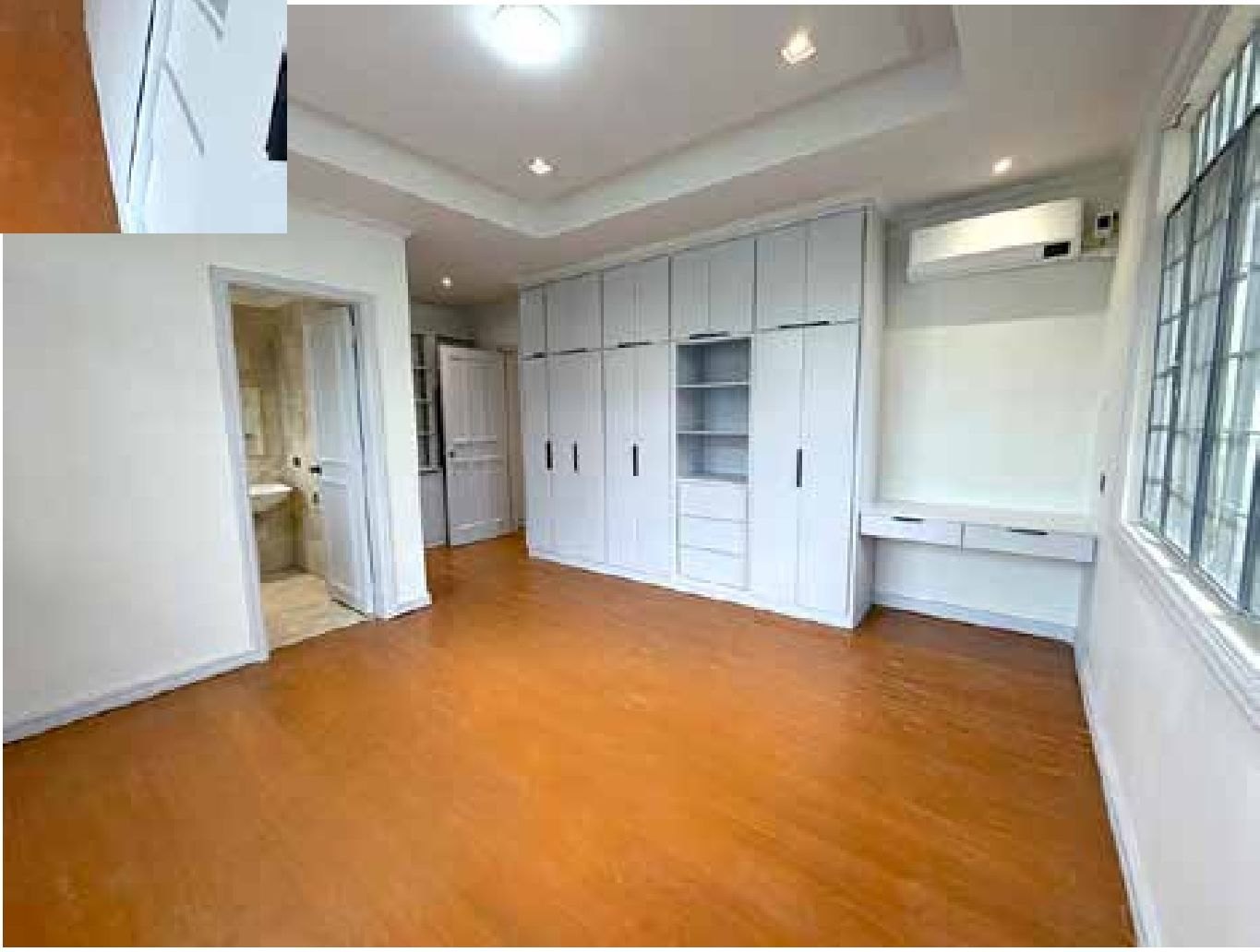 Bedroom with full-height built-in closets and vanity counter