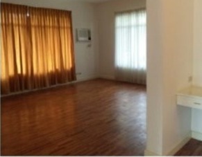 Main bedroom with hardwood flooring and large windows