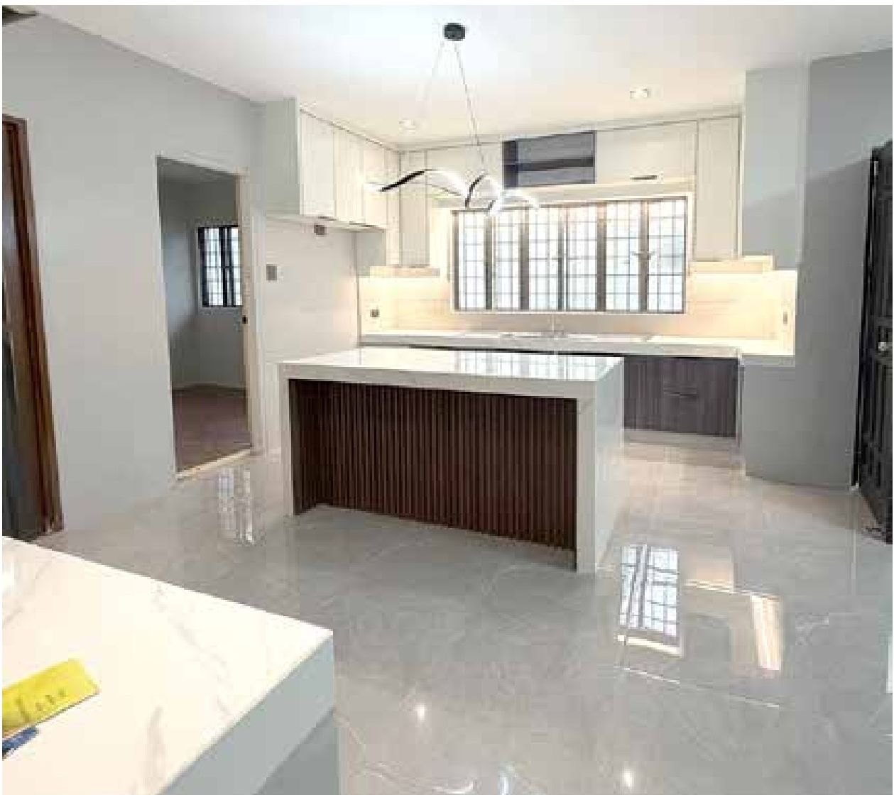 New kitchen island with slatted timber base and white cabinetry