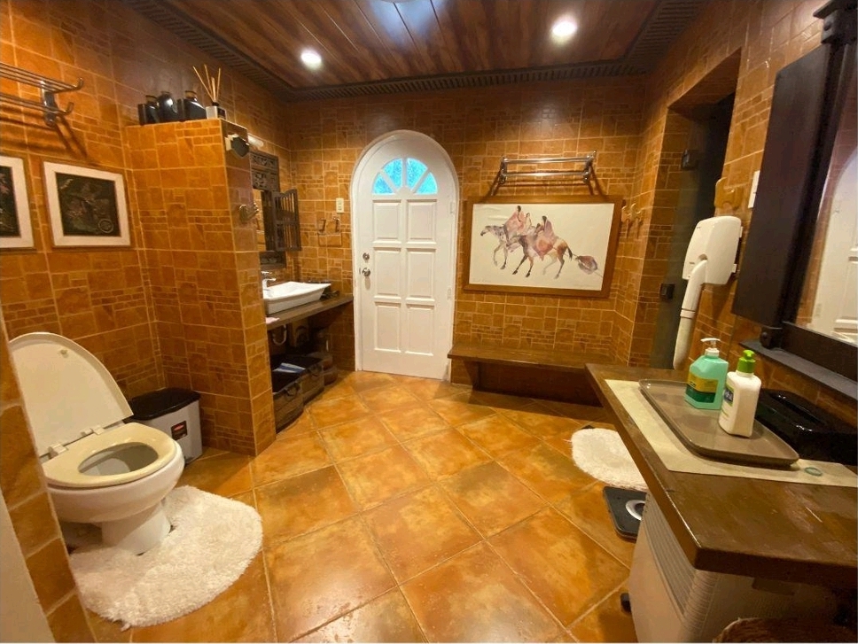Bathroom with twin vanities and tiled walls