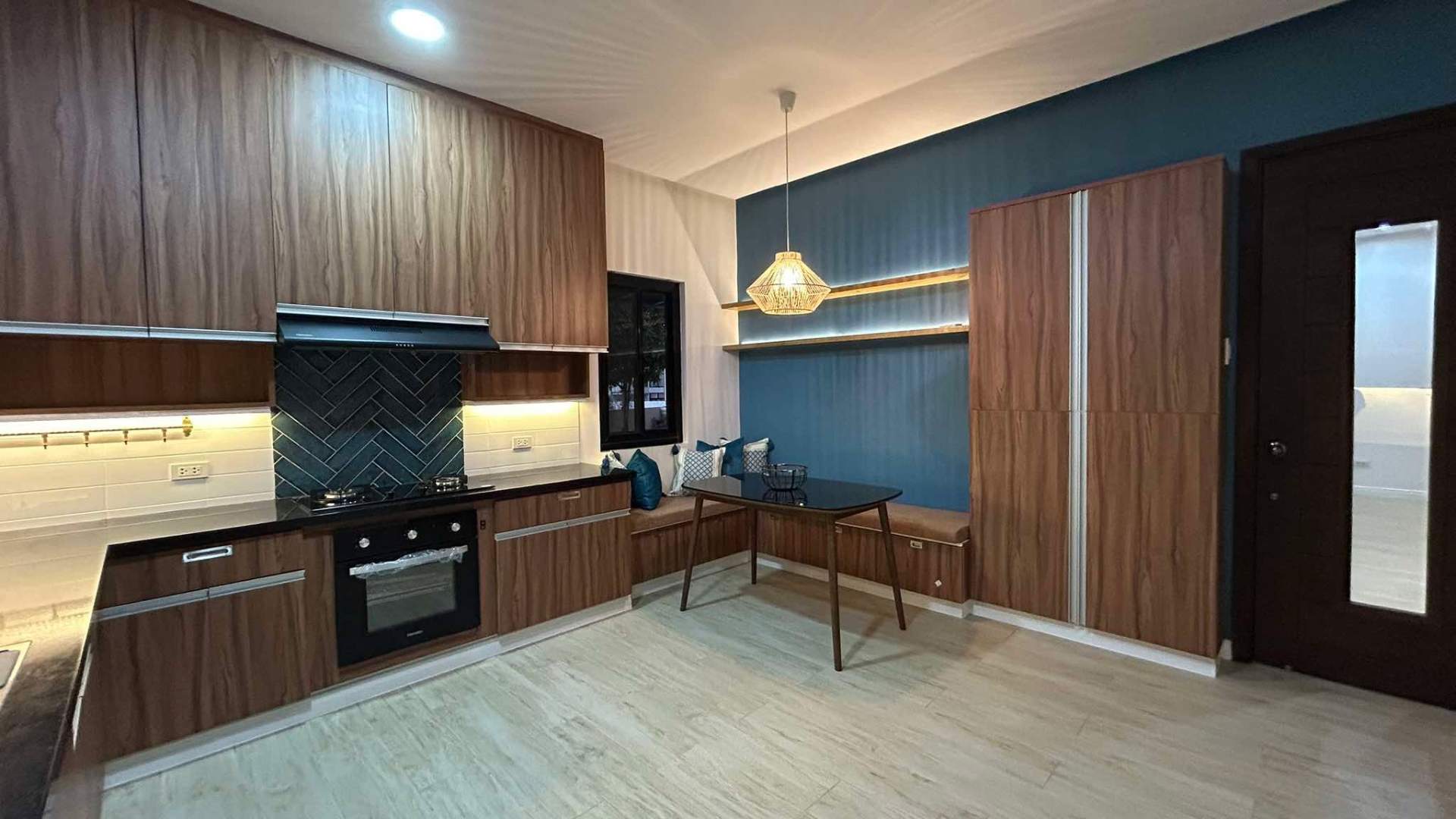 Auxiliary kitchen and breakfast nook with built-in banquette
